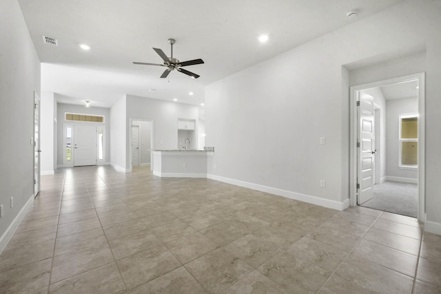 unfurnished living room featuring ceiling fan