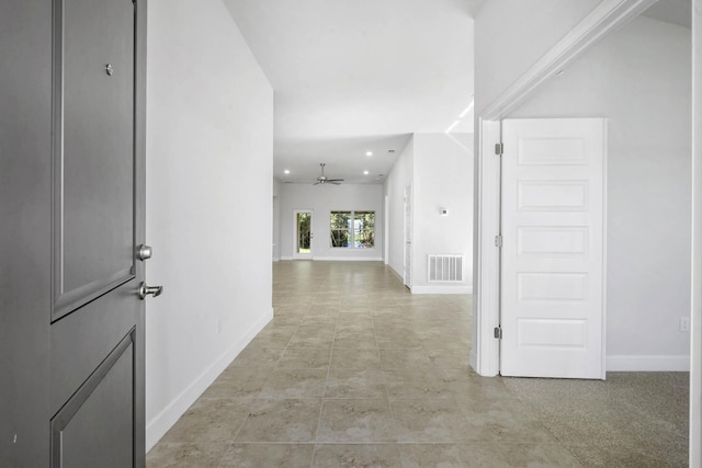 hall with light tile patterned floors