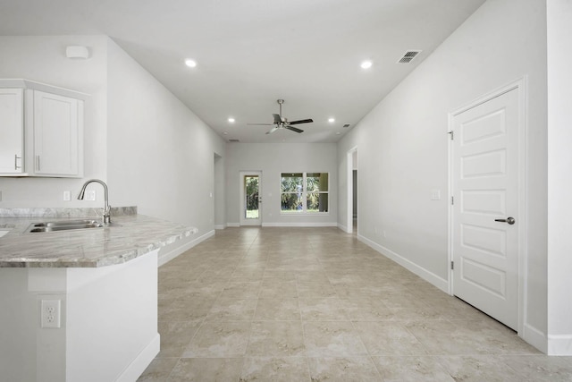 interior space with ceiling fan and sink