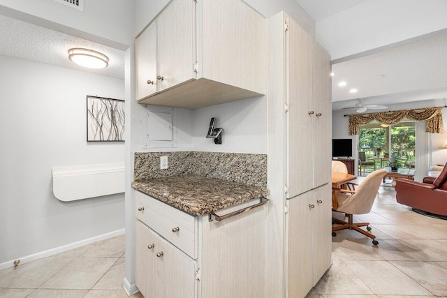 kitchen featuring a textured ceiling, ceiling fan, and light tile patterned floors