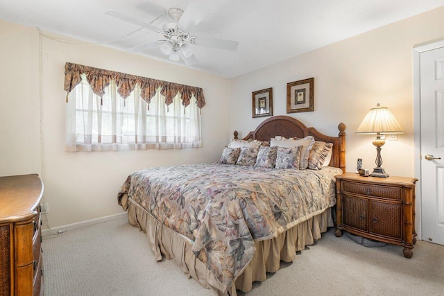 bedroom featuring ceiling fan and light colored carpet