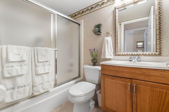 full bathroom featuring tile patterned floors, toilet, bath / shower combo with glass door, and vanity