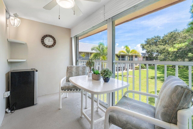 sunroom with a healthy amount of sunlight and ceiling fan