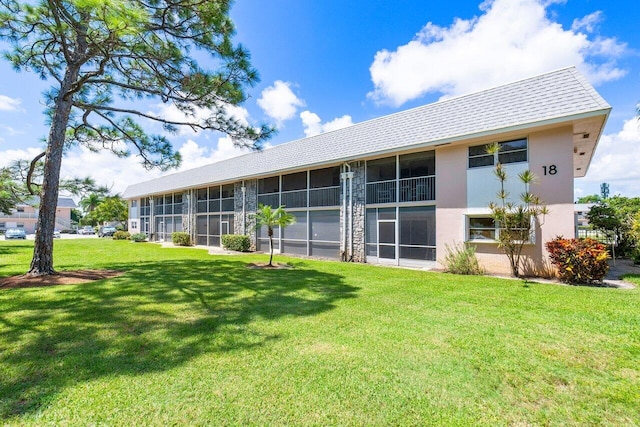 back of property featuring a lawn