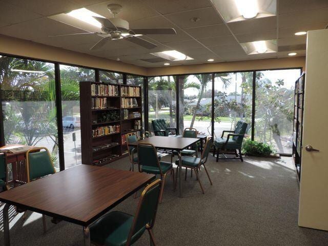 sunroom with a wealth of natural light, ceiling fan, and a drop ceiling