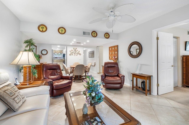 carpeted living room with ceiling fan