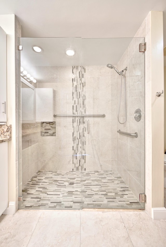 bathroom featuring a shower with shower door