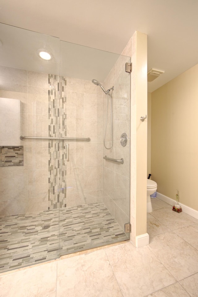 bathroom with tile patterned floors, toilet, and walk in shower