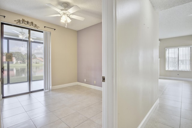 tiled spare room with a textured ceiling