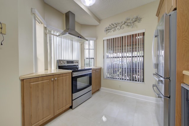 kitchen featuring a textured ceiling, stainless steel appliances, and range hood