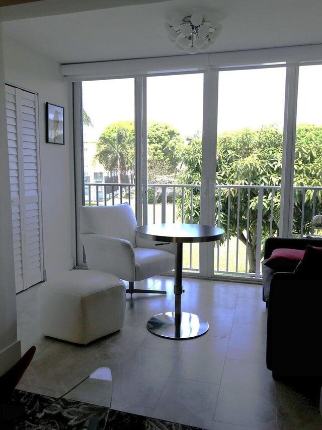 interior space with a healthy amount of sunlight, a chandelier, and tile patterned floors