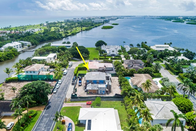 birds eye view of property with a water view and a residential view
