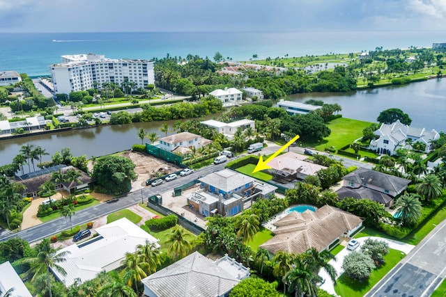 drone / aerial view featuring a residential view and a water view