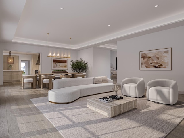 living room with light wood-type flooring and a tray ceiling