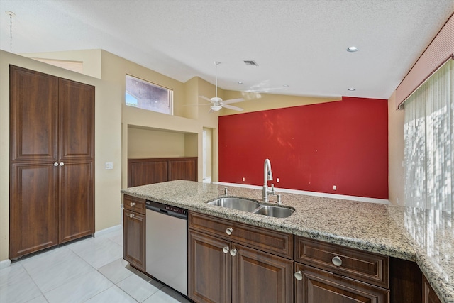 kitchen with vaulted ceiling, a textured ceiling, ceiling fan, stainless steel dishwasher, and sink