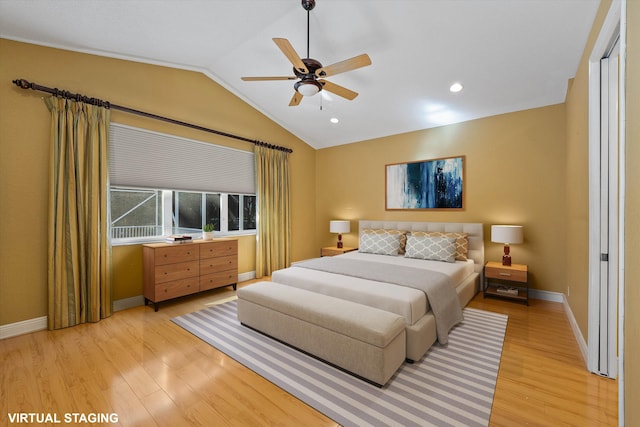 bedroom with ceiling fan, vaulted ceiling, and light hardwood / wood-style floors