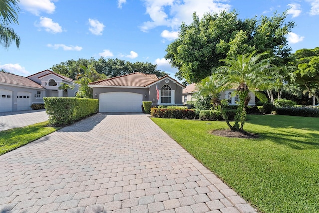 10860 Fairmont Village Dr, Lake Worth, FL 33449 - mediterranean / spanish-style house featuring a tiled roof, a front yard, decorative driveway, and a garage