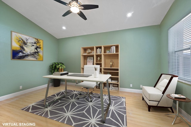 office featuring ceiling fan, light hardwood / wood-style flooring, and lofted ceiling