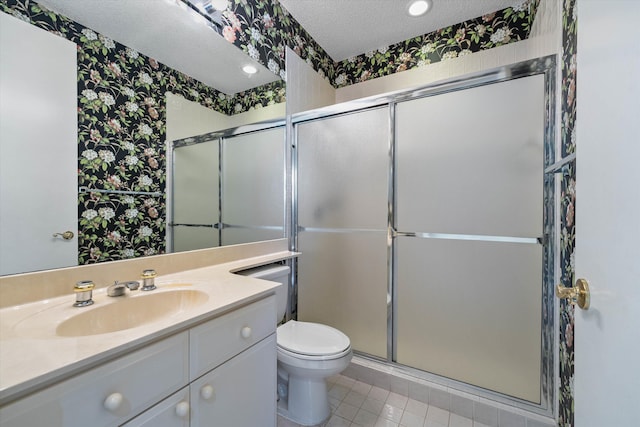 bathroom with a textured ceiling, tile patterned floors, a shower with shower door, vanity, and toilet