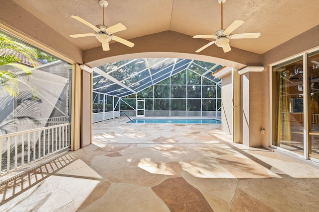 view of patio featuring a lanai and ceiling fan