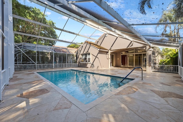 view of pool with a patio and glass enclosure