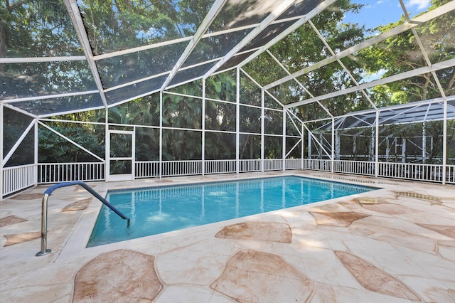 view of pool with a lanai and a patio