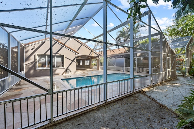 view of swimming pool with a lanai and a patio area