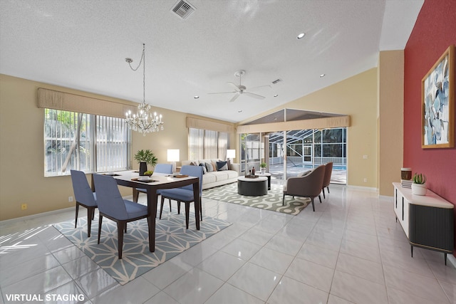 tiled dining space featuring ceiling fan with notable chandelier, vaulted ceiling, and a textured ceiling