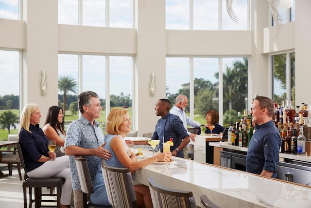 dining space with a high ceiling and indoor bar