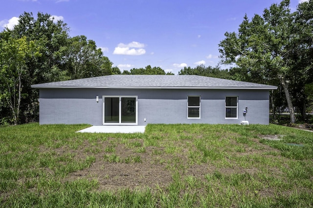 3534 NW 32nd Ave, Okeechobee, FL 34972 - rear view of house with a lawn and roof with shingles