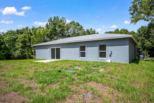 rear view of property with a yard