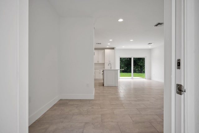 spare room featuring light tile patterned floors and sink