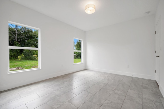 spare room featuring light tile patterned floors