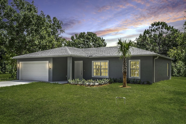 3534 NW 32nd Ave, Okeechobee, FL 34972 - ranch-style home featuring roof with shingles, a front lawn, a garage, concrete driveway, and stucco siding