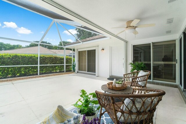 sunroom / solarium featuring ceiling fan