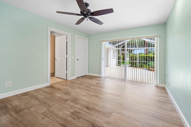 unfurnished room with a ceiling fan, light wood-style floors, and baseboards