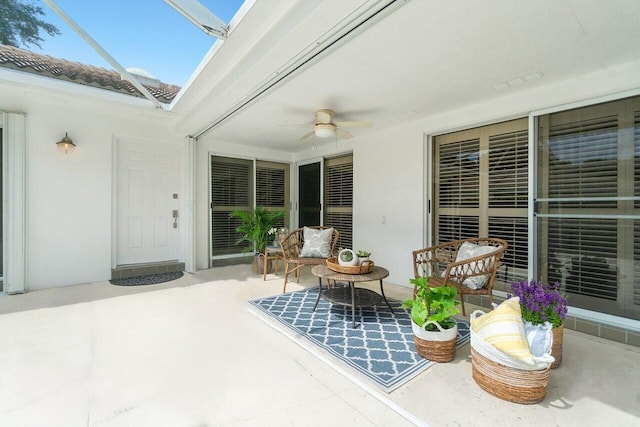 view of patio featuring a lanai and ceiling fan