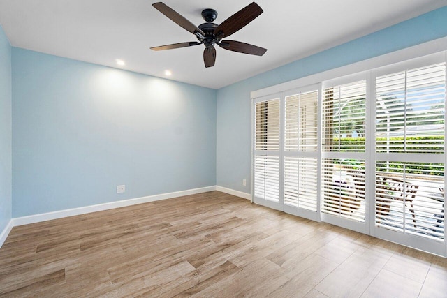 unfurnished room with a ceiling fan, recessed lighting, wood finished floors, and baseboards