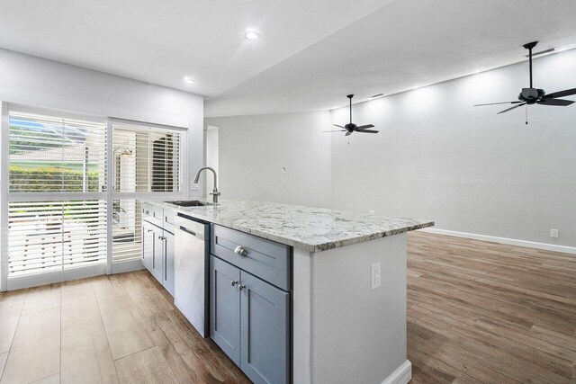 kitchen with light hardwood / wood-style flooring, ceiling fan, dishwasher, and sink