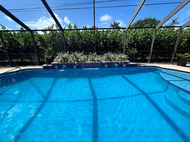 view of pool with a lanai