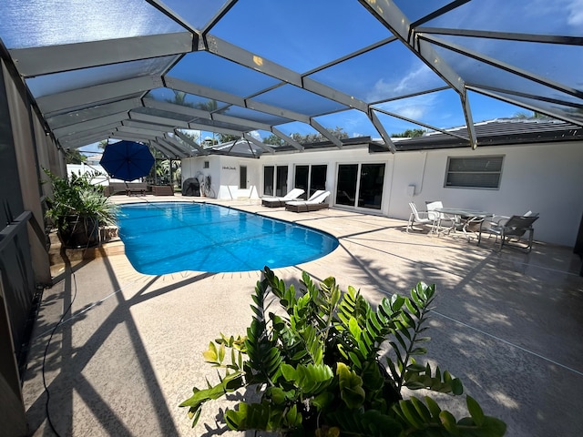 view of pool with a lanai and a patio area