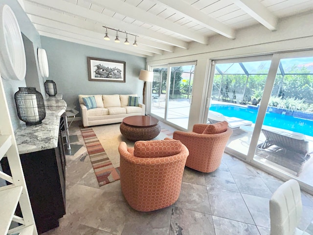 sunroom with rail lighting and beam ceiling