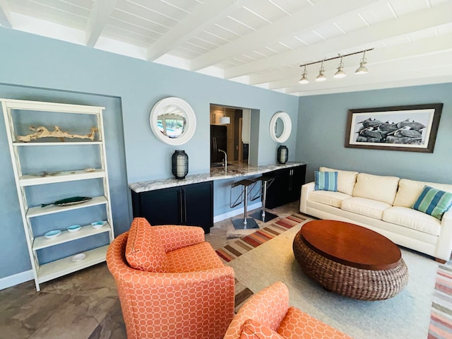 living room featuring beamed ceiling