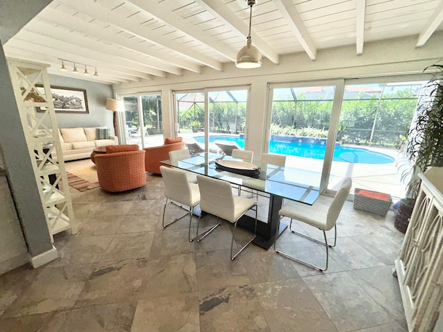 sunroom featuring a wealth of natural light, beamed ceiling, a pool, and wood ceiling