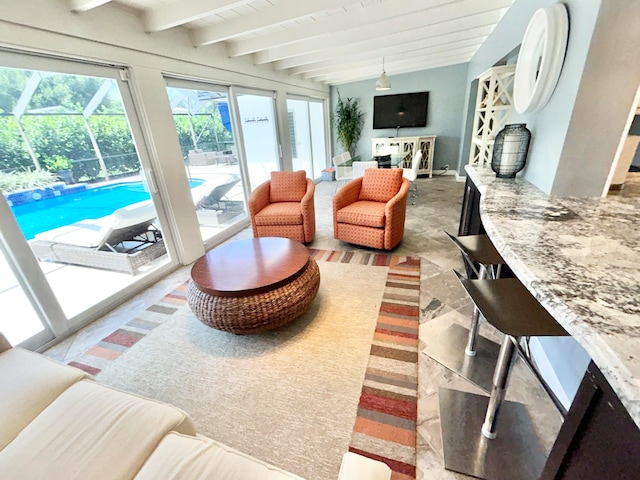 sunroom featuring beam ceiling