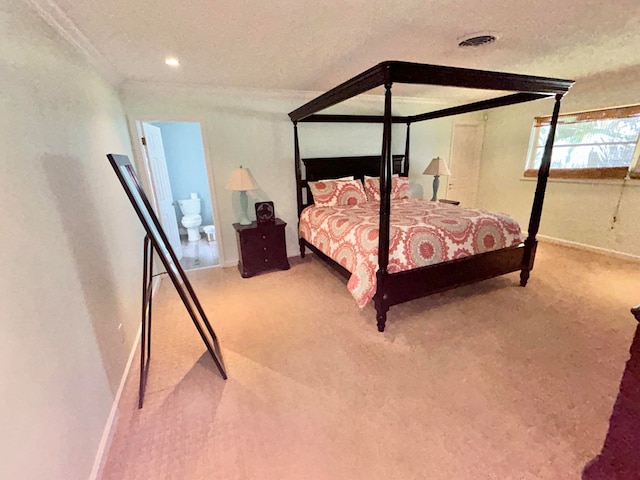 bedroom with a textured ceiling, carpet flooring, and ornamental molding