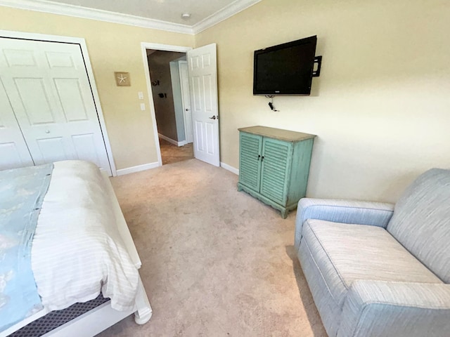 bedroom featuring crown molding, light colored carpet, and a closet