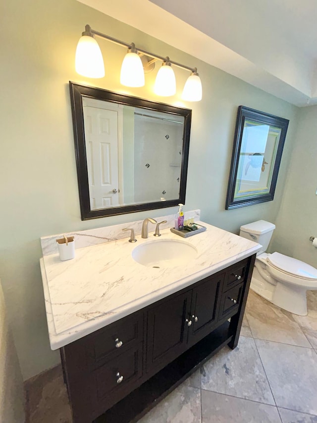 bathroom with vanity, toilet, and tile patterned floors