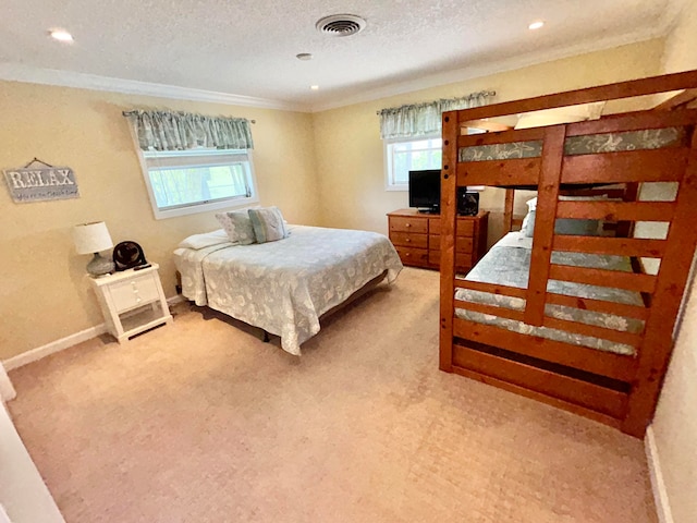 bedroom featuring crown molding, light carpet, and a textured ceiling