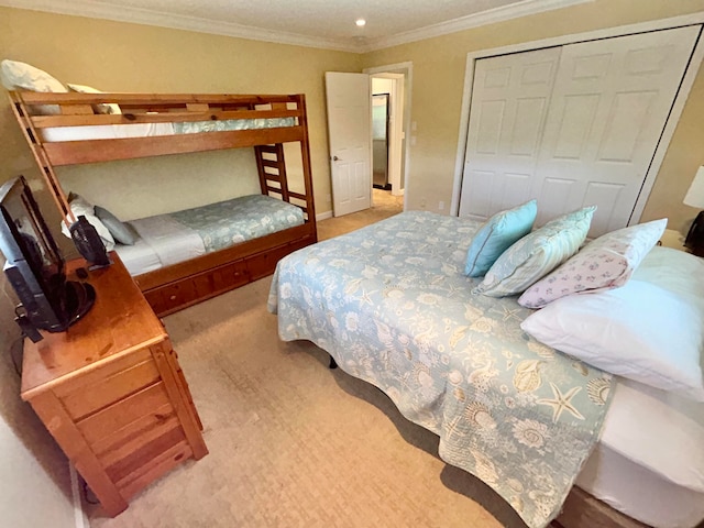 bedroom featuring a closet, carpet flooring, and ornamental molding